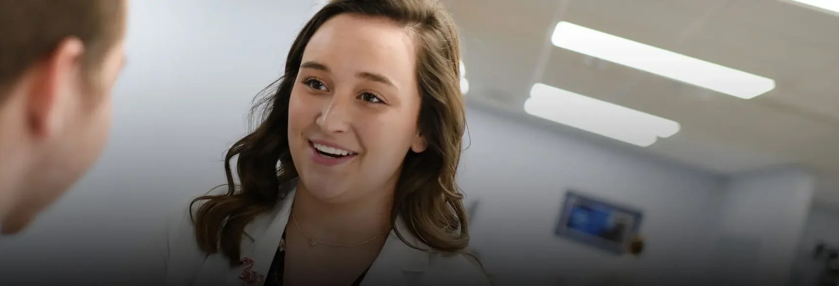 a woman smiling at a man